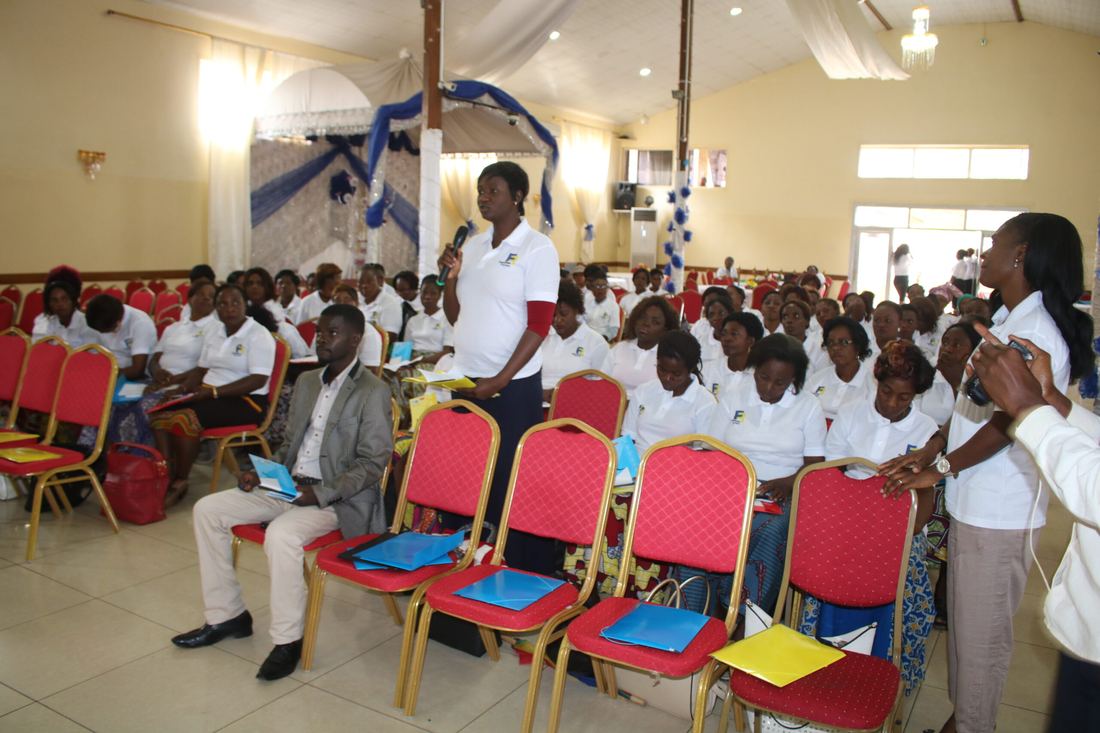 A DYFREN member addresses fellow women members with a microphone during a training workshop